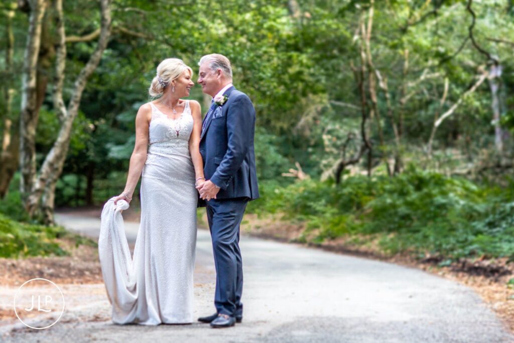 Relaxed wedding photography of a newlywed couple sharing a quiet, romantic moment in the castle grounds.