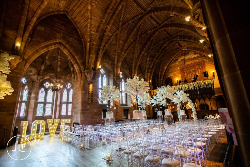 The stunning Great Hall set up for an elegant castle wedding ceremony at Peckforton Castle in Cheshire.