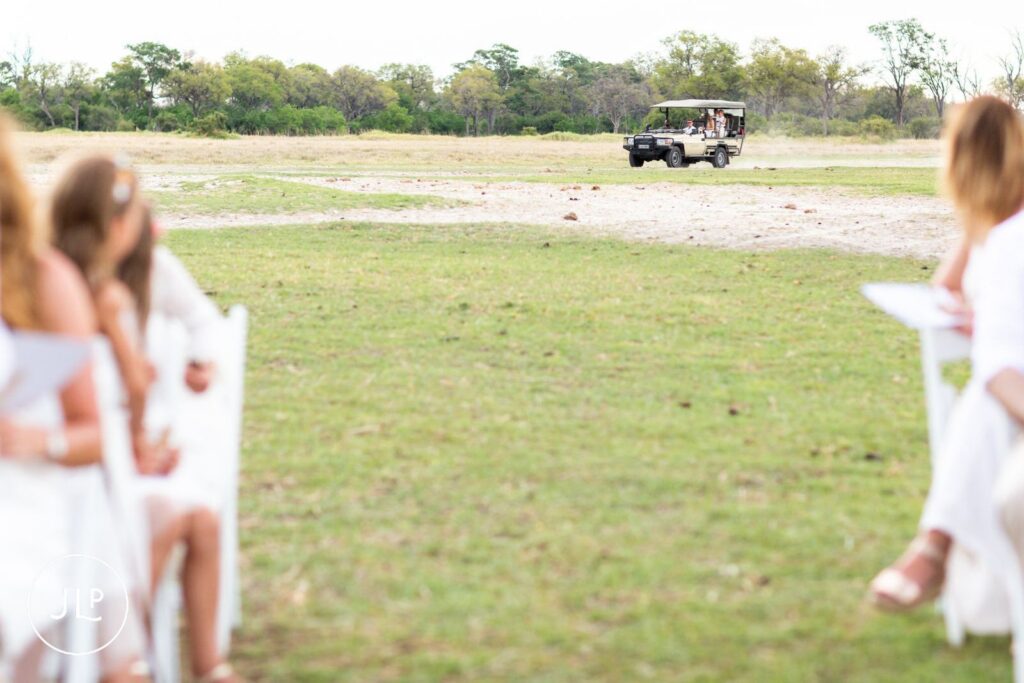 A safari vehicle approaches the outdoor ceremony location, captured by a safari wedding photographer Botswana.