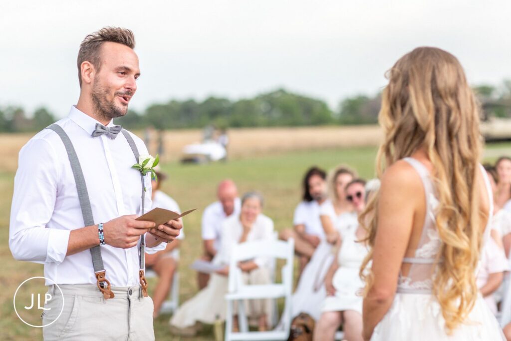 A groom reading his wedding vows to his bride, captured by an experienced Botswana safari wedding photographer.