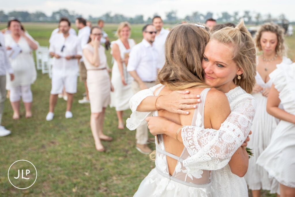 A guest hugging the bride tightly, captured by a professional Botswana destination wedding photographer.