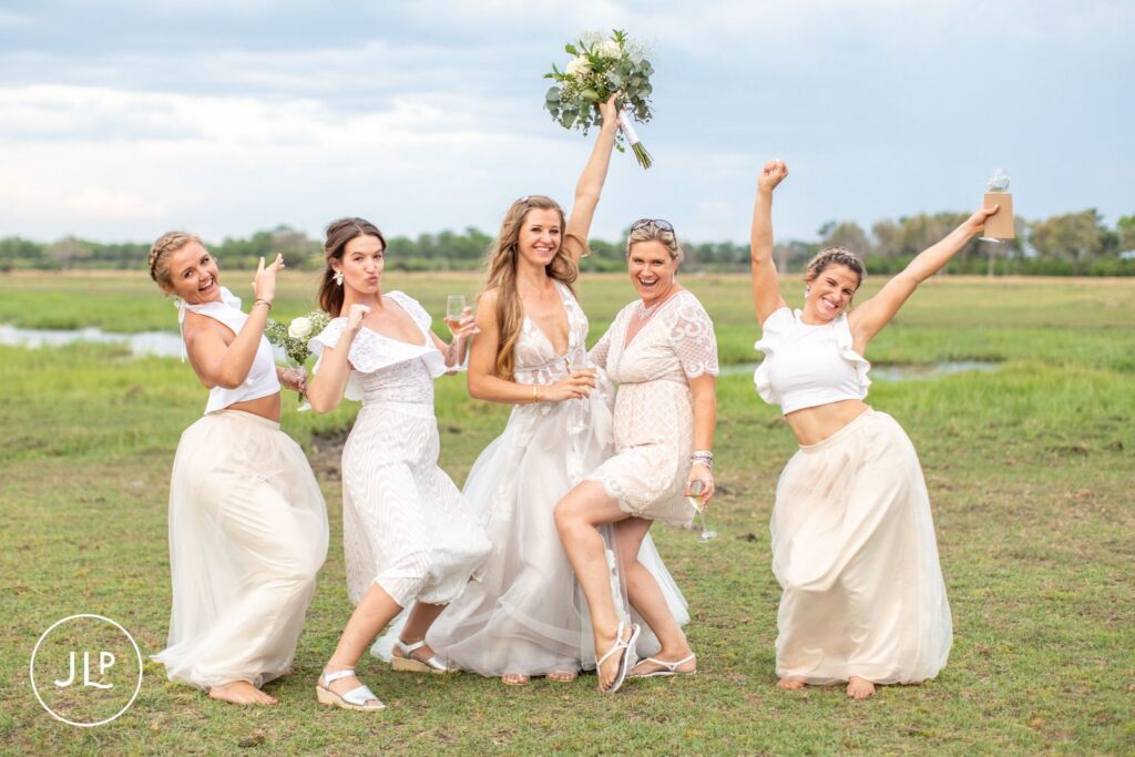 Natural wedding photography Botswana style of a bride and her bridesmaids celebrating in the bush.