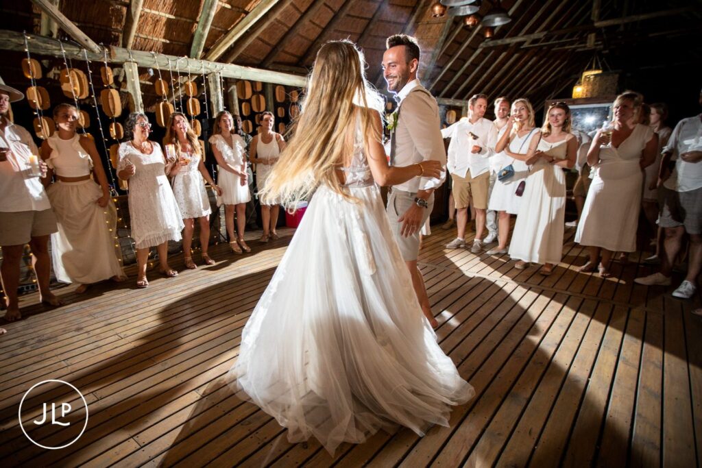A bride with long hair spinning during a first dance on a wooden deck at a luxury safari wedding Botswana.