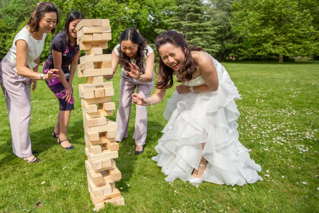 Bride and bridesmaids playing giant jenga lawn game