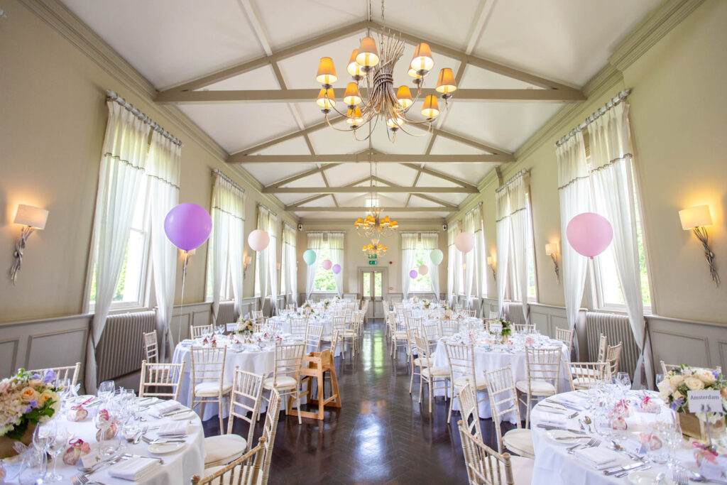Wedding breakfast room at Morden Hall with pastel decorations
