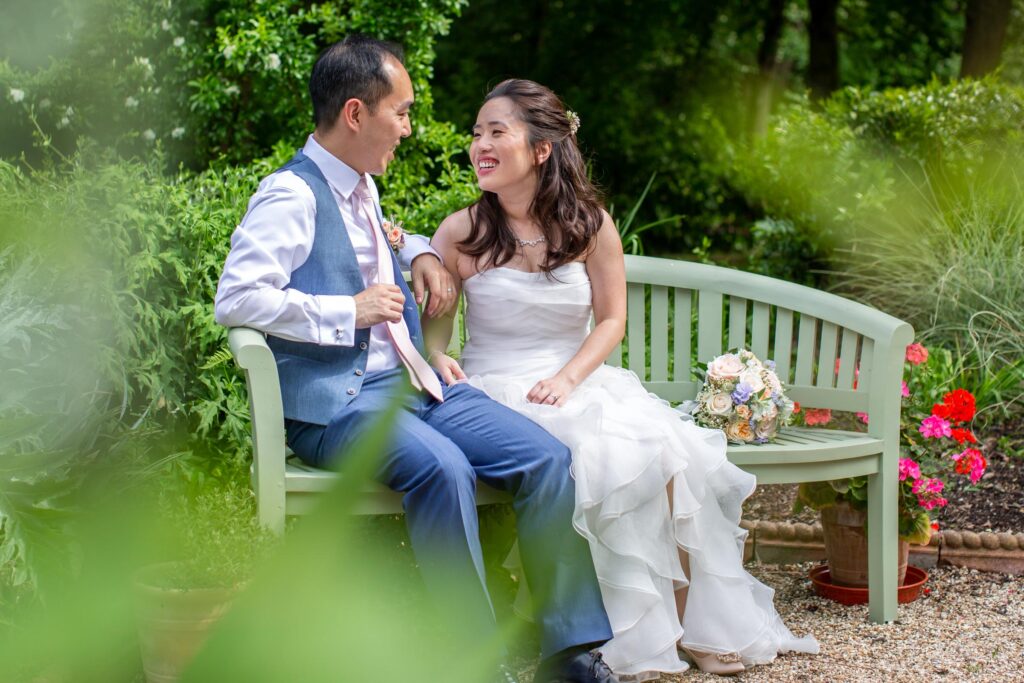 Bride and groom sitting on pretty bench