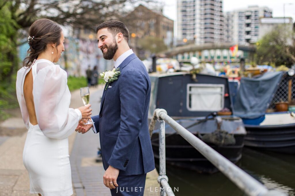 Natural wedding photographer London capturing a candid moment between newlyweds by the Regent's Canal.
