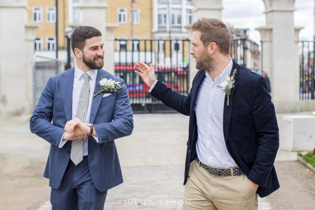Candid wedding photography London of the groom and best man arriving at the Stoke Newington wedding venue.