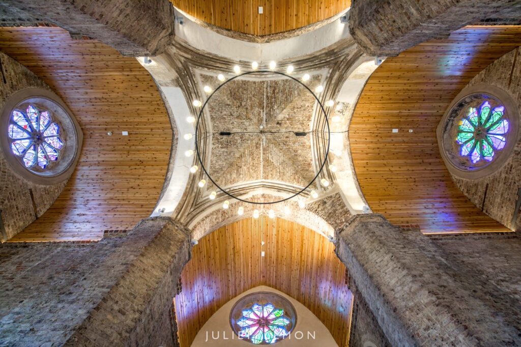 Looking up at the vaulted ceiling and stained glass by an Abney Park Chapel wedding photographer.