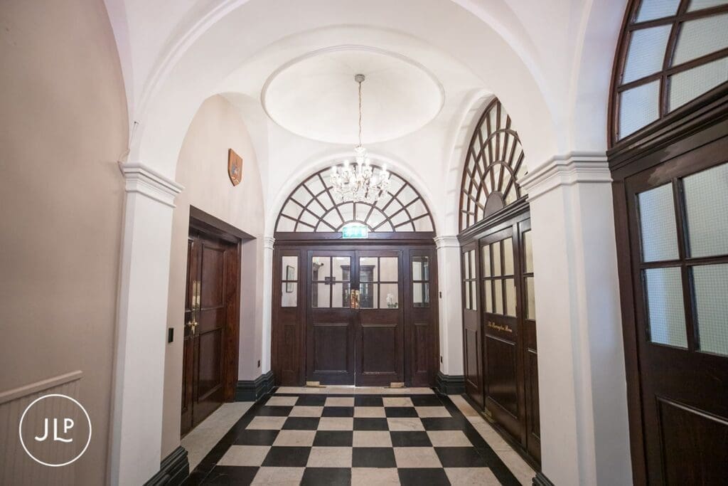 Historic black and white tiled hallway inside the Chelsea registry office wedding venue.