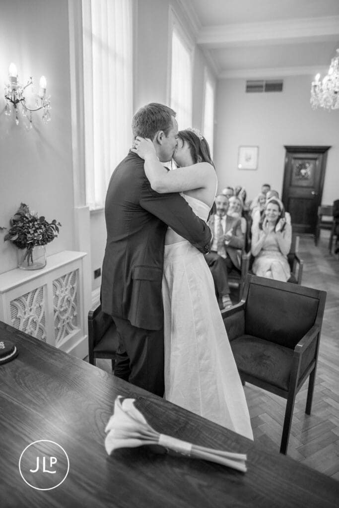 First kiss candid moment captured by a London intimate wedding photographer during a Chelsea registry office wedding.