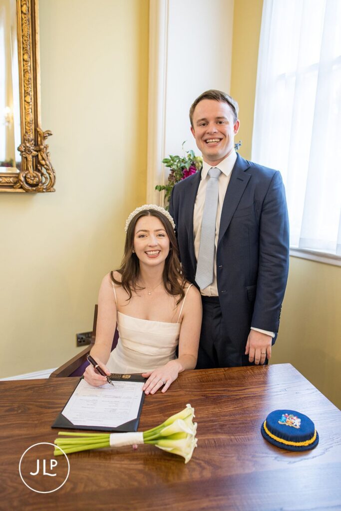 Erin signing the marriage register at Chelsea Old Town Hall.