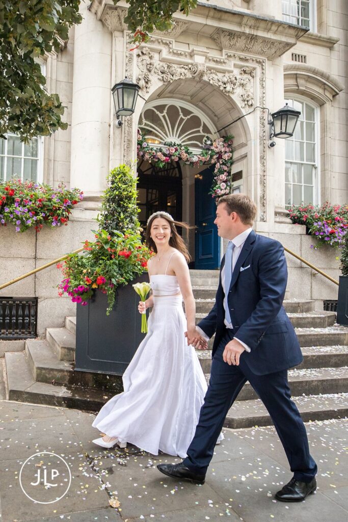 Newlyweds walking down the iconic stone steps after their London registry office ceremony.