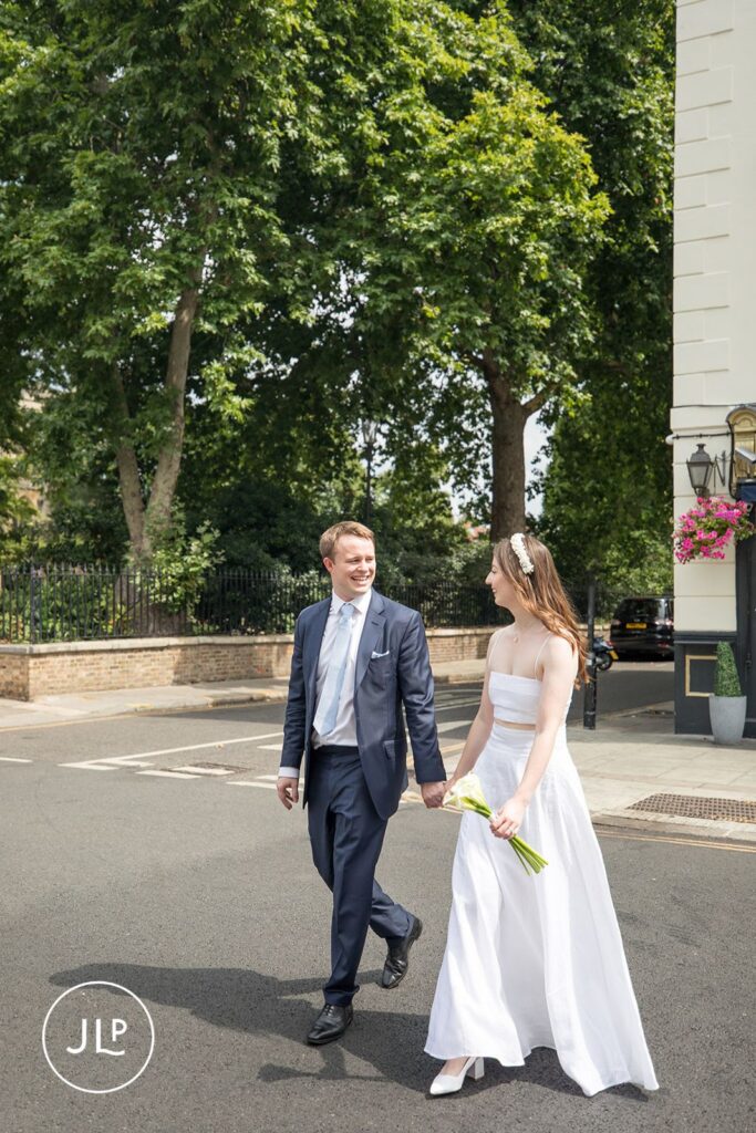 Bride and groom strolling through Chelsea towards their wedding breakfast at Daphne's.