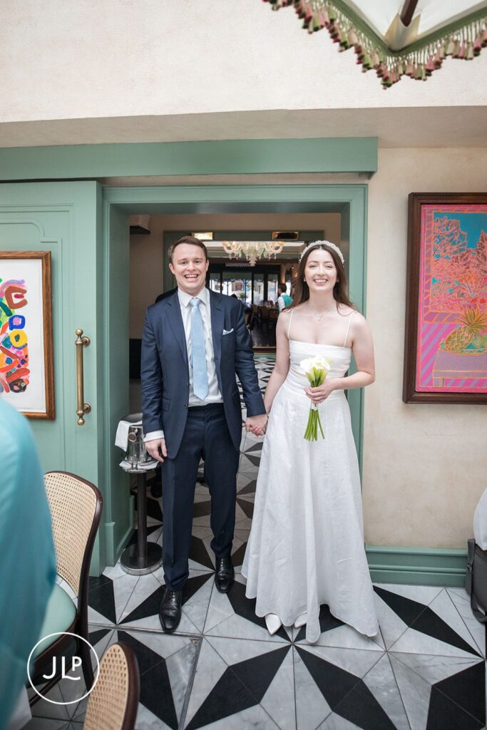 Erin and Robert entering Daphne’s Chelsea for their intimate wedding reception.