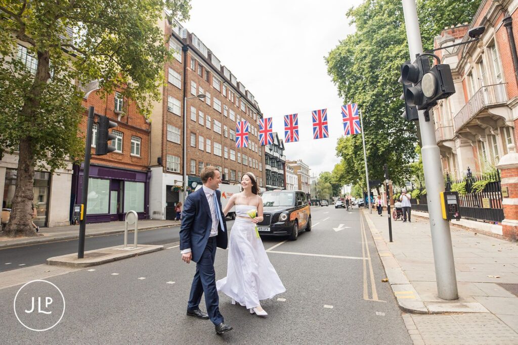 Bride and groom strolling through Chelsea towards their wedding breakfast at Daphne's.