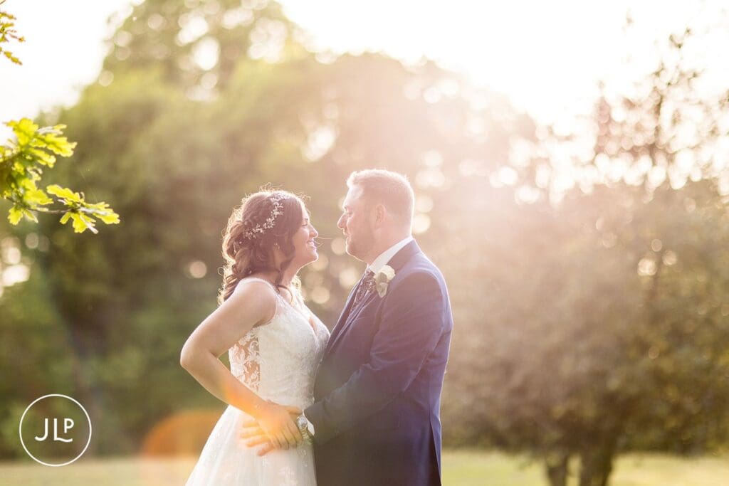 Couple walking through gardens at Hartsfield Manor