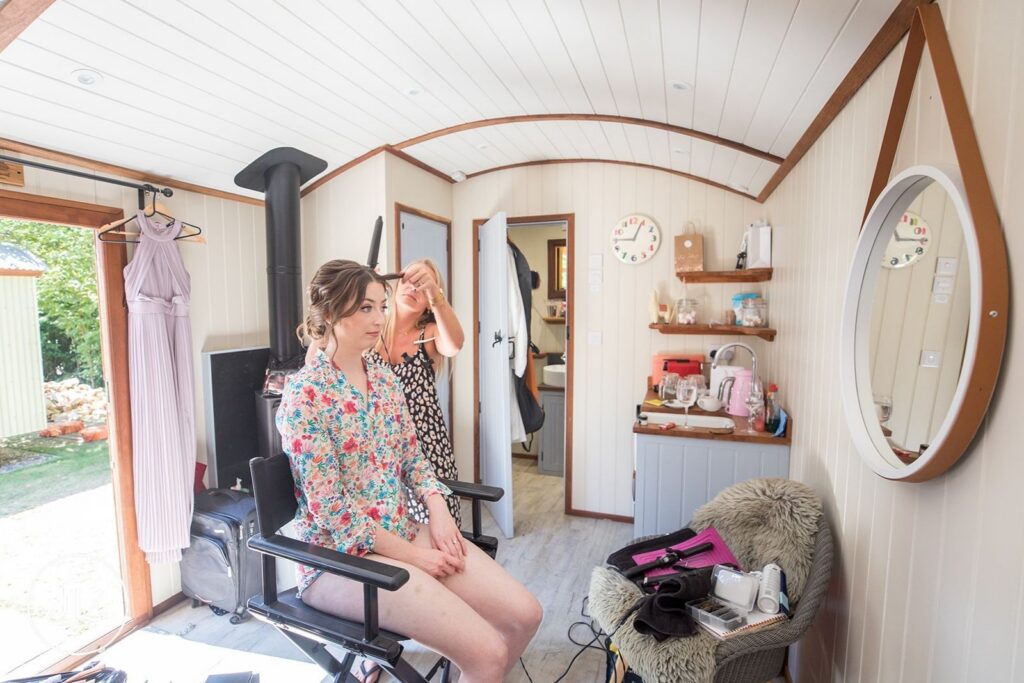 Bride receiving professional hair styling before her Surrey countryside wedding.