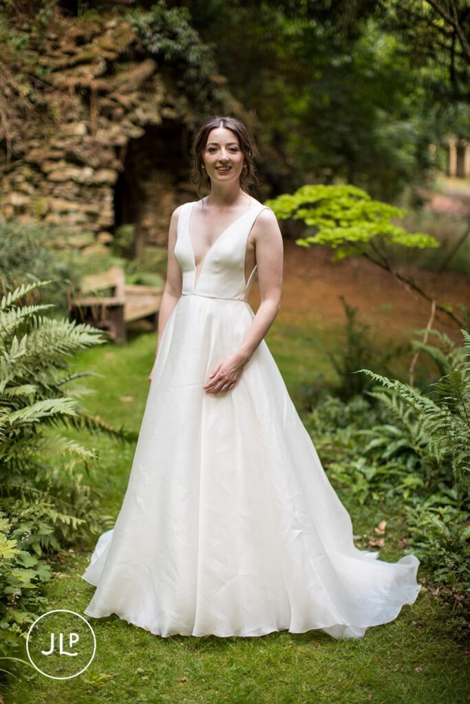 Stunning solo portrait of the bride in her white gown, a signature look for a luxury Surrey marquee wedding.