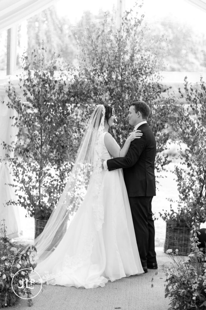 Black and white photo of the bride and groom at their marquee wedding photography UK session.