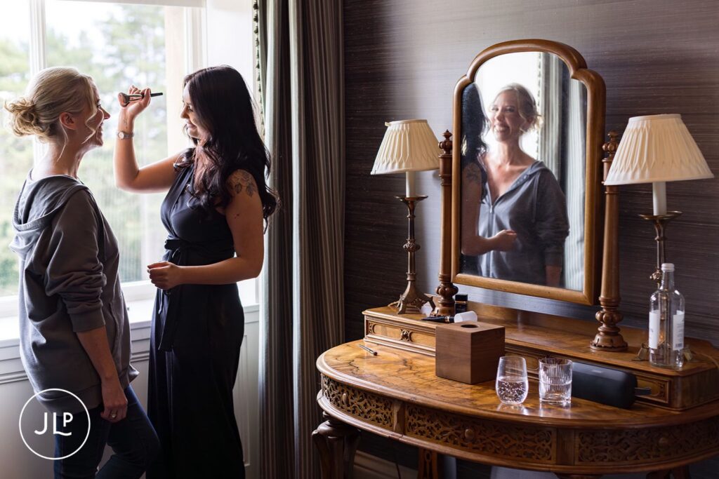 Bride-to-be smiling during makeup for a Cliveden House wedding.