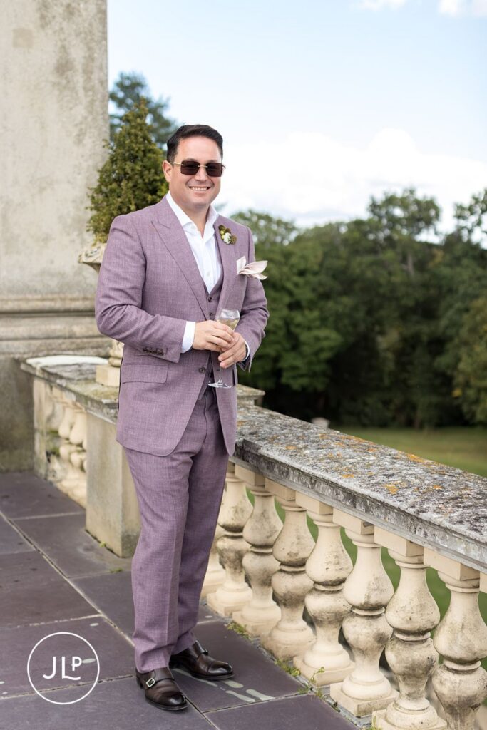 Groom portrait featuring classic Cliveden House photography on terrace.