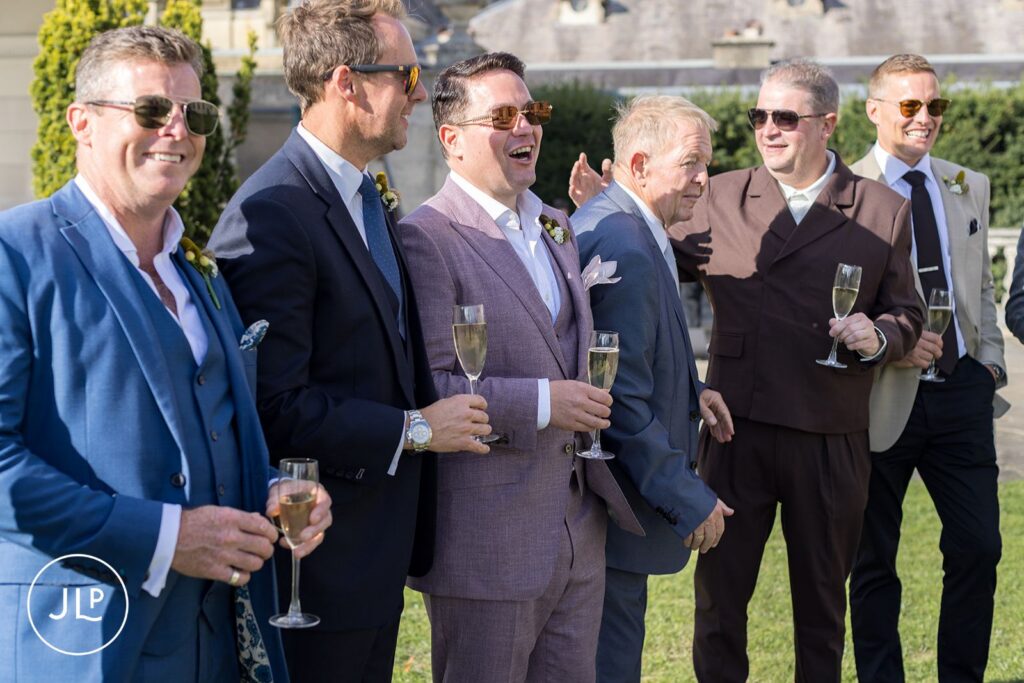 Groom toasting with guests at a Cliveden House wedding.