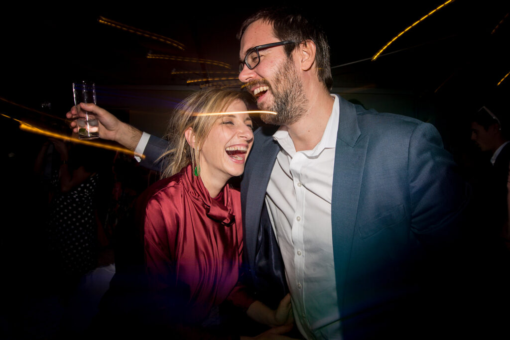 Candid laughter on the dance floor during an unforgettable Portugal destination wedding party.