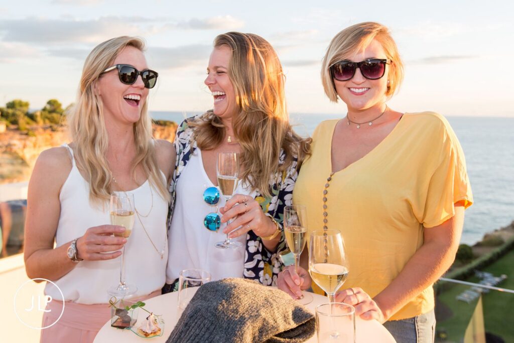 Friends enjoying drinks at a luxury Algarve wedding welcome party at the Tivoli resort.