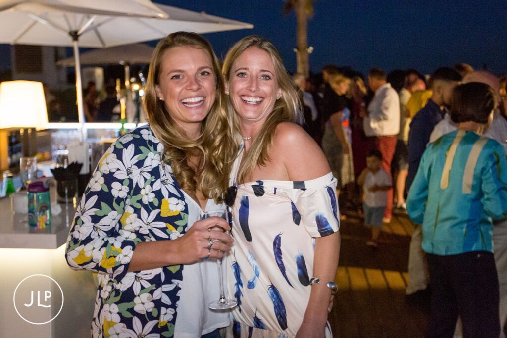 Happy guests at a luxury Algarve wedding welcome party at Tivoli Carvoeiro resort.