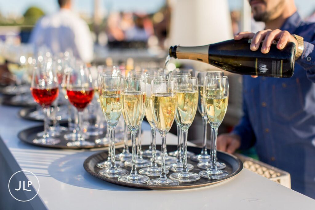 Serving champagne at a luxury Algarve wedding welcome party at Tivoli Carvoeiro resort.