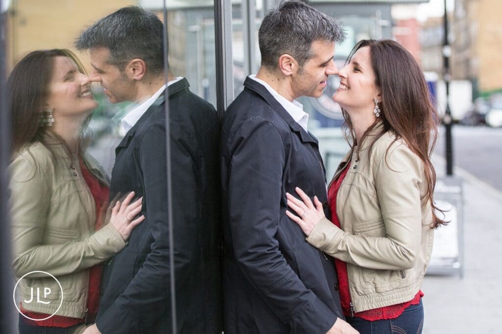 Romantic couple portrait with window reflection, captured during a London engagement photography session.
