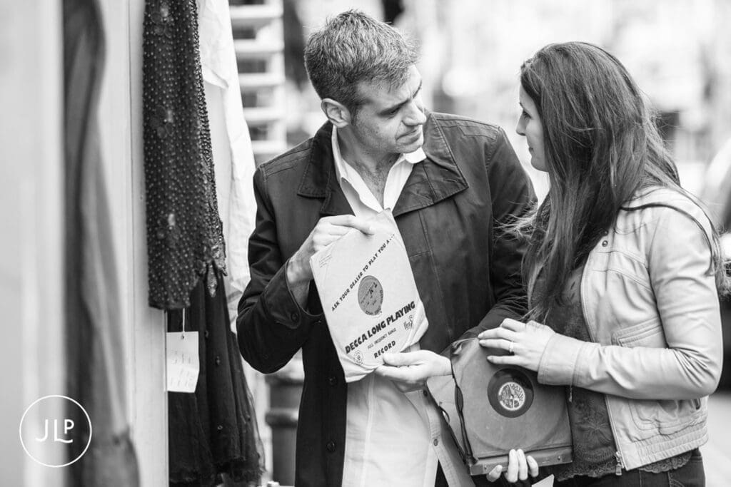 Black and white portrait of a couple holding records, by an East London wedding photographer.