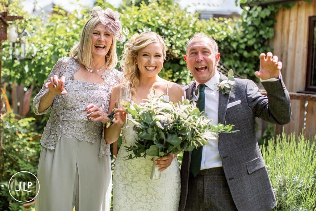 Relaxed wedding photography of a bride and her family at Hampton Court House Surrey wedding venue.