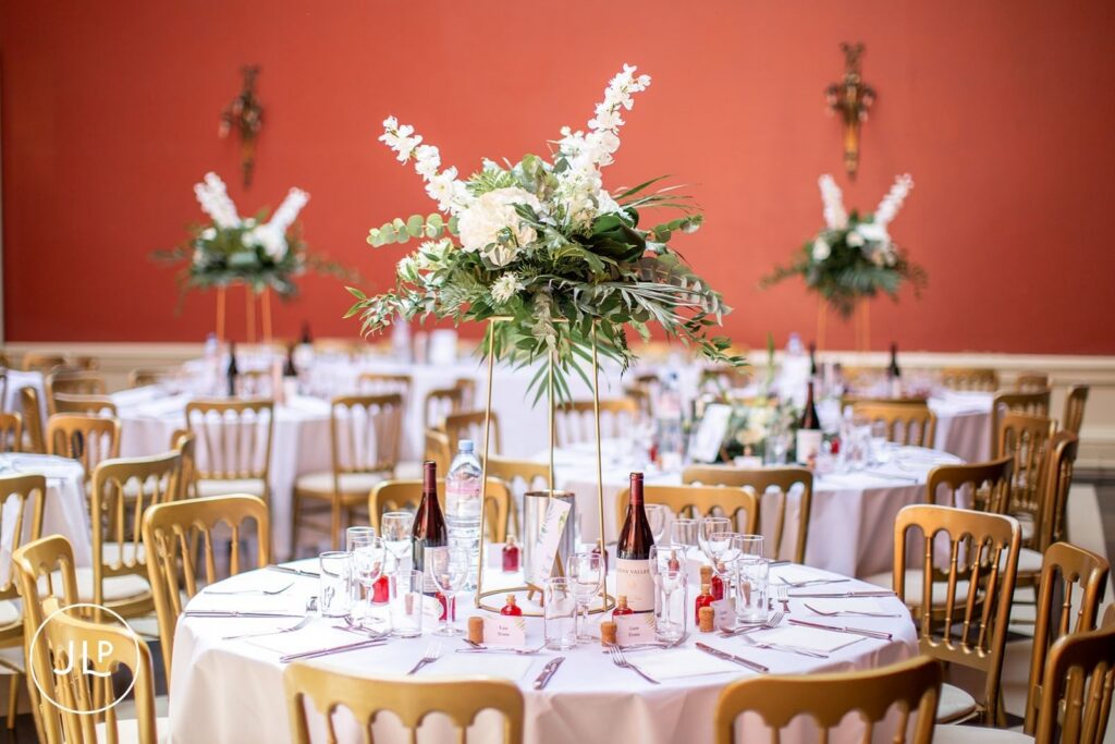 Elegant Surrey wedding venue table setup with white floral centerpieces for Hampton Court House weddings.