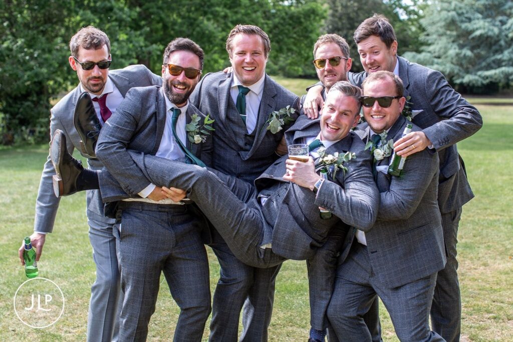 Fun, natural wedding photography of groomsmen by a London wedding photographer at a Hampton Court House wedding.
