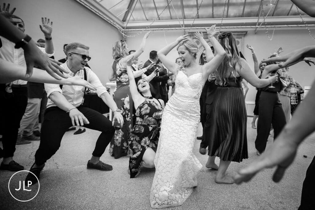 Candid wedding photography of a bride dancing at her reception, by a London wedding photographer.
