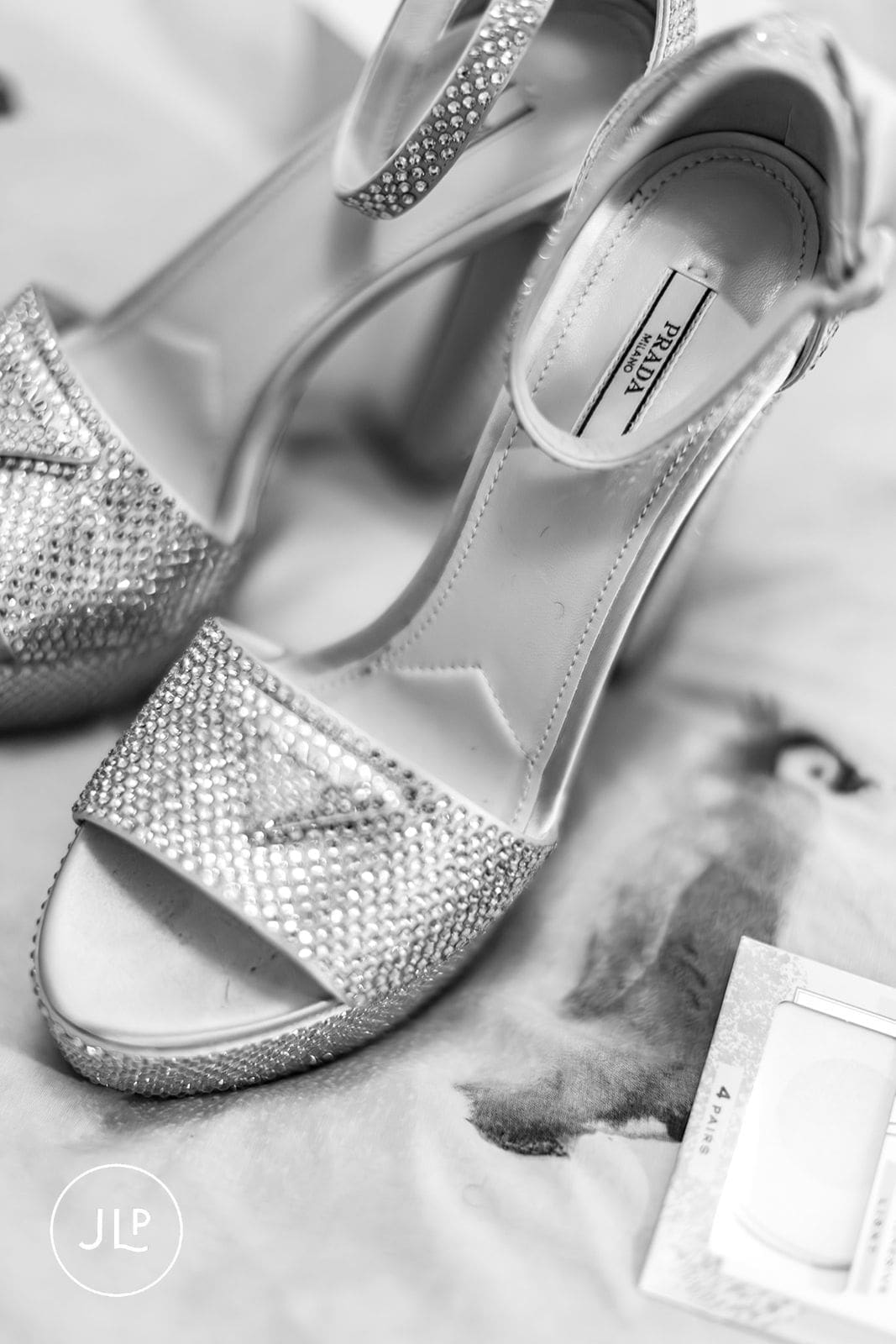 Close-up of silver Prada bridal heels with rhinestones for a glamorous London wedding celebration.