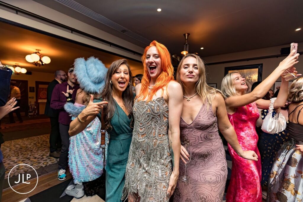 Stylish London wedding photographer captures the bride and guests laughing on the dance floor in Central London.