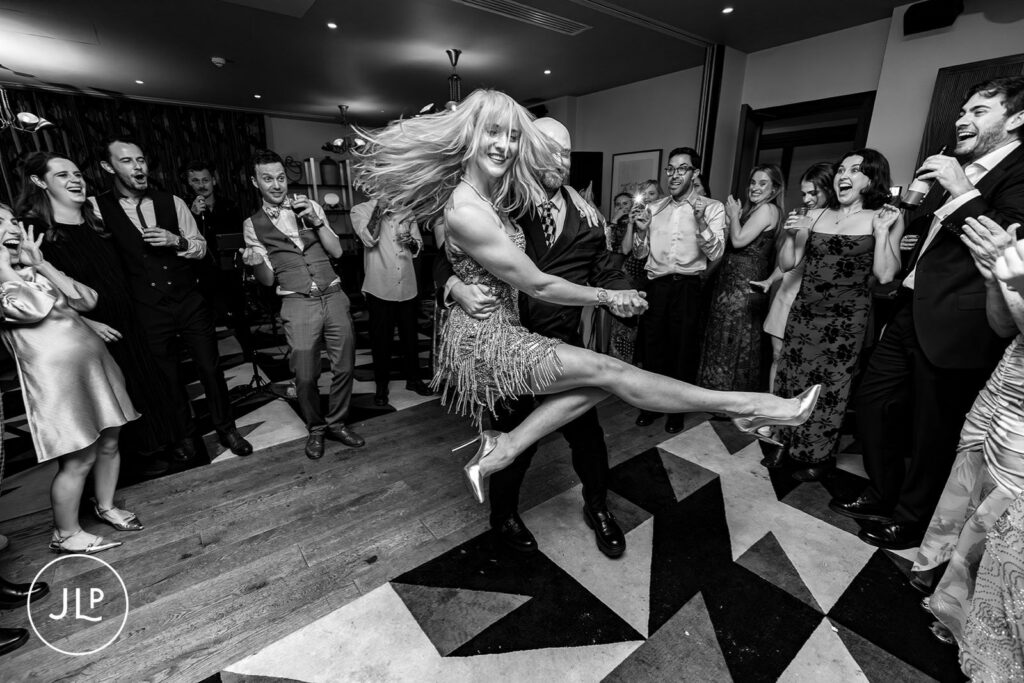 Stylish London wedding photographer captures the bride dancing during a lively London city wedding reception.