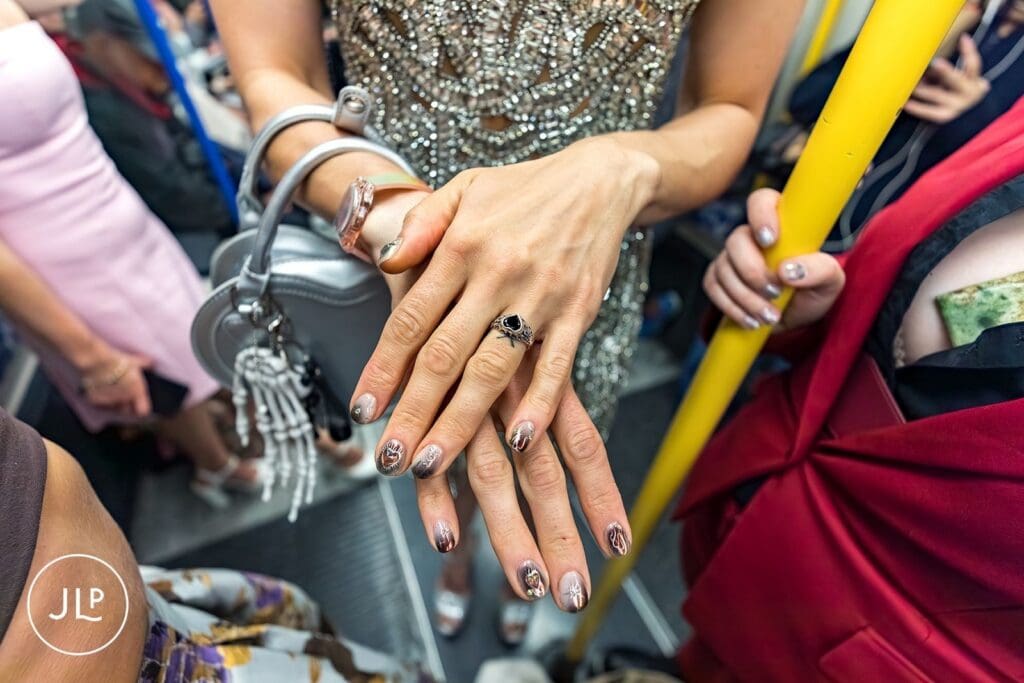 A close-up showing the bride's unique heart-shaped ring and artistic celestial nail art.