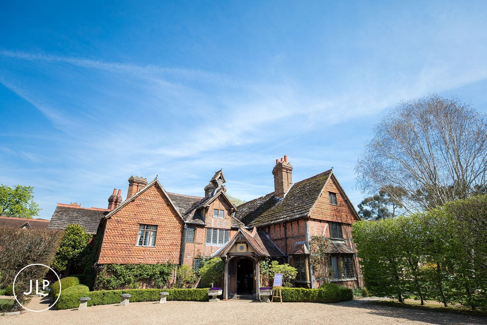 The beautiful historic brick exterior of Langshott Manor, a boutique wedding venue Surrey.