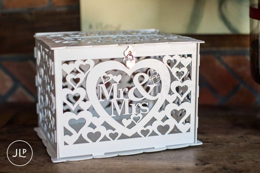 "Mr & Mrs" white heart-cutout card box at a Langshott Manor luxury wedding in Surrey.