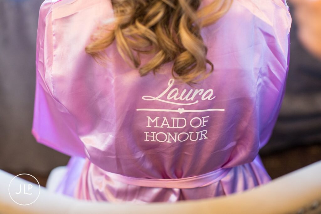 Close up of Maid of Honour robe during preparations at a luxury Langshott Manor wedding in Surrey.