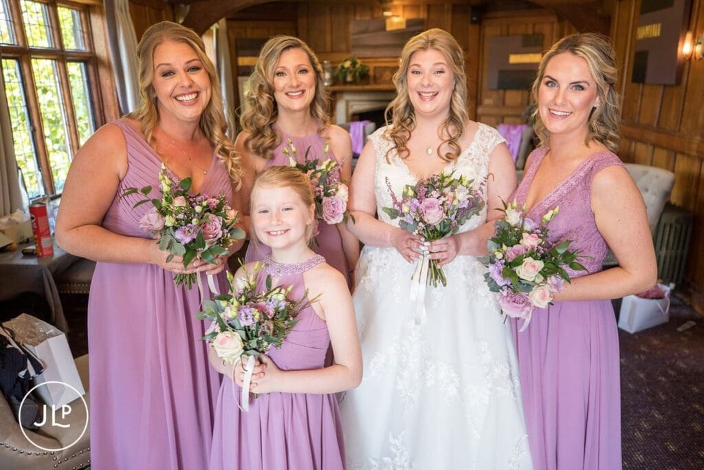 Portrait of the bride and bridesmaids at Langshott Manor, a beautiful Tudor wedding venue Surrey.