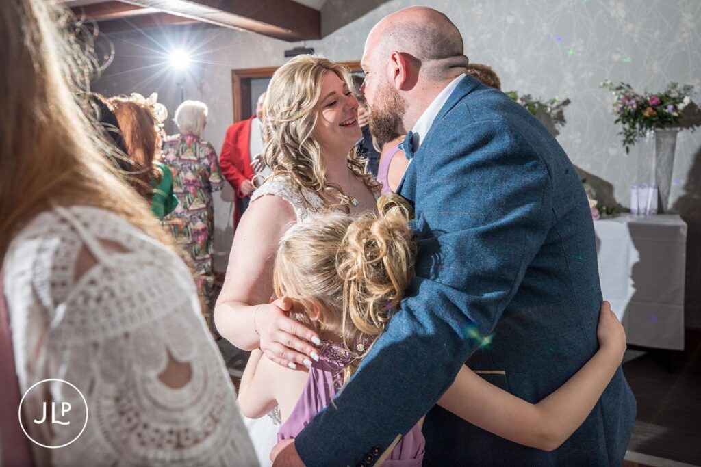 Close-up of the bride and groom sharing an emotional moment during their wedding reception celebrations.
