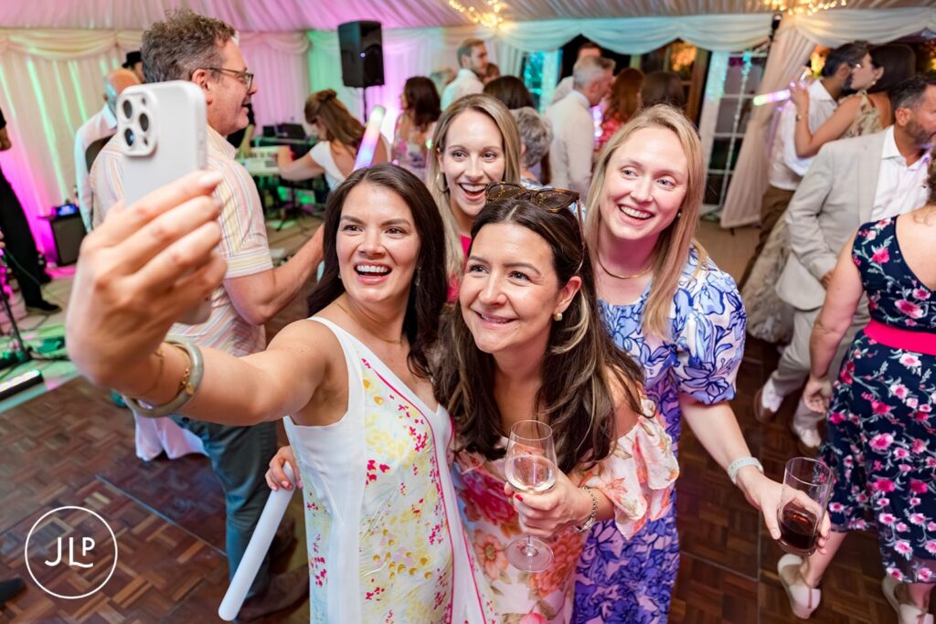 Candid wedding photography of guests during a Surrey wedding reception party.