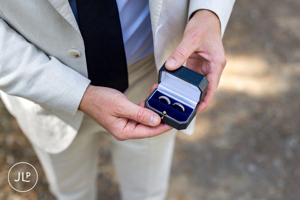 Close-up of wedding rings in a box, captured by a professional Surrey wedding photographer.