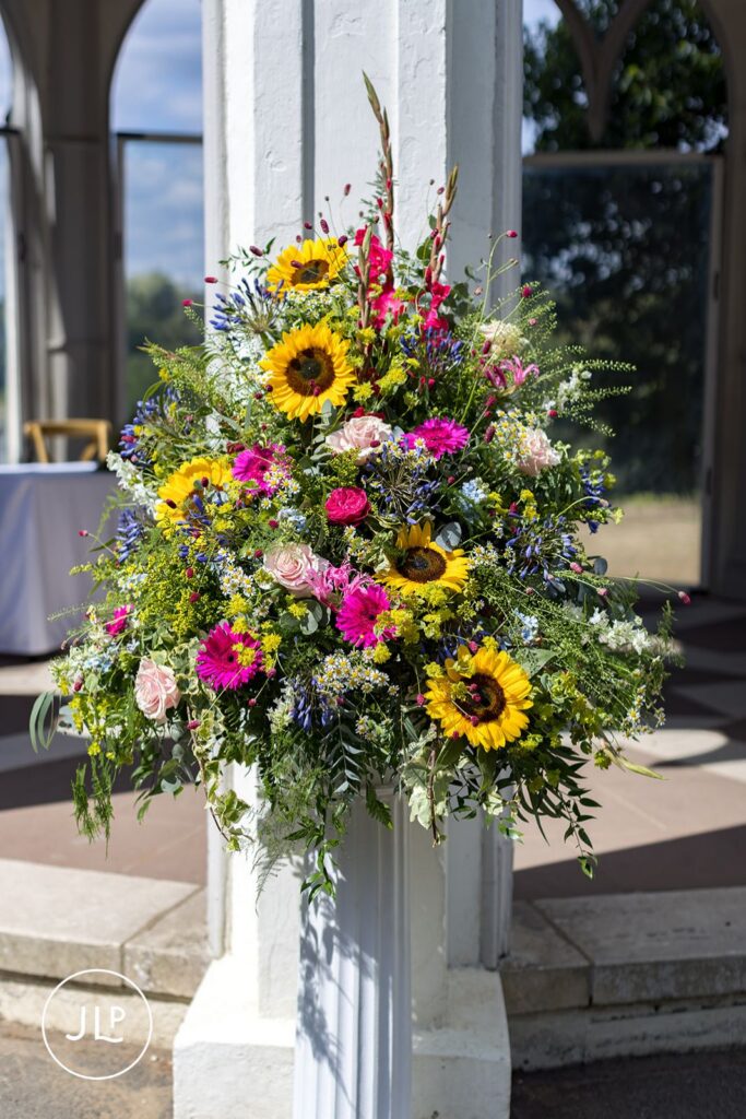 Colorful outdoor Surrey wedding floral display.