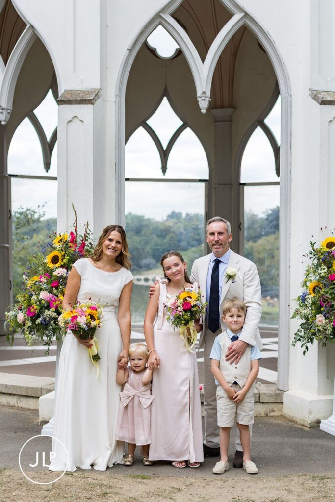 A relaxed family portrait at the Gothic Temple, captured by a Painshill Park wedding photographer.
